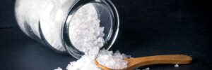 salt pouring out on table with spoon