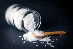 salt pouring out on table with spoon